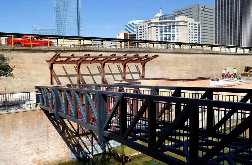 Crews worked last month on a new pedestrian bridge, stairway and shade structures being...