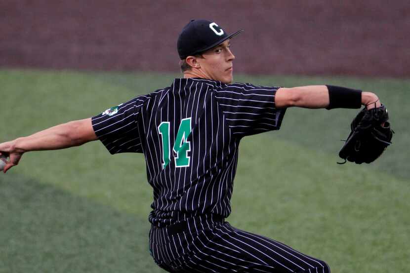 Southlake Carroll pitcher Griffin Herring (14) delivers a pitch to a Keller batter during...