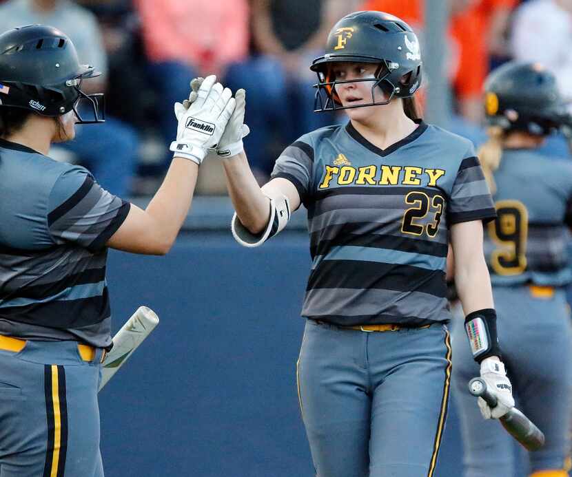 Forney shortstop Caleigh Cross (23) is congratulated by Trinity Cannon (left) after Cross...