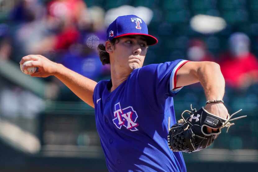 Texas Rangers pitcher Cole Winn delivers during the fifth inning of a spring training game...