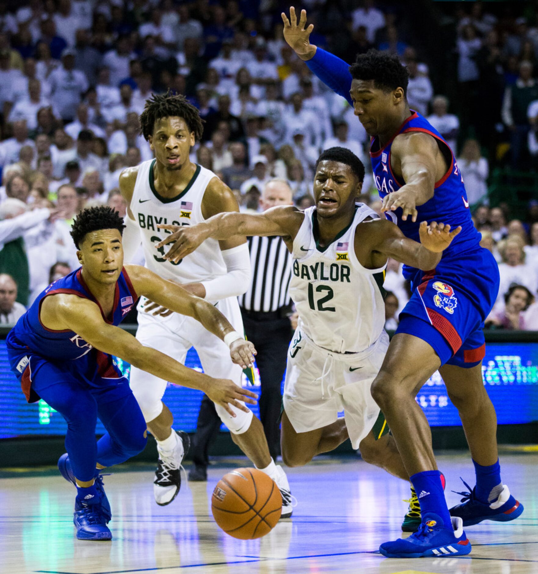 Baylor Bears guard Jared Butler (12) is fouled by Kansas Jayhawks forward David McCormack...