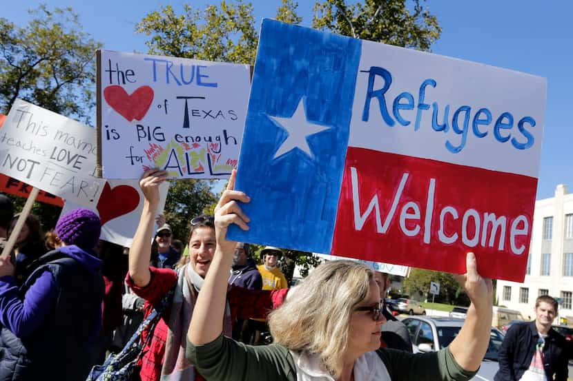Members of  The Syrian People Solidarity Group protest Texas Gov. Greg Abbott’s refusal to...