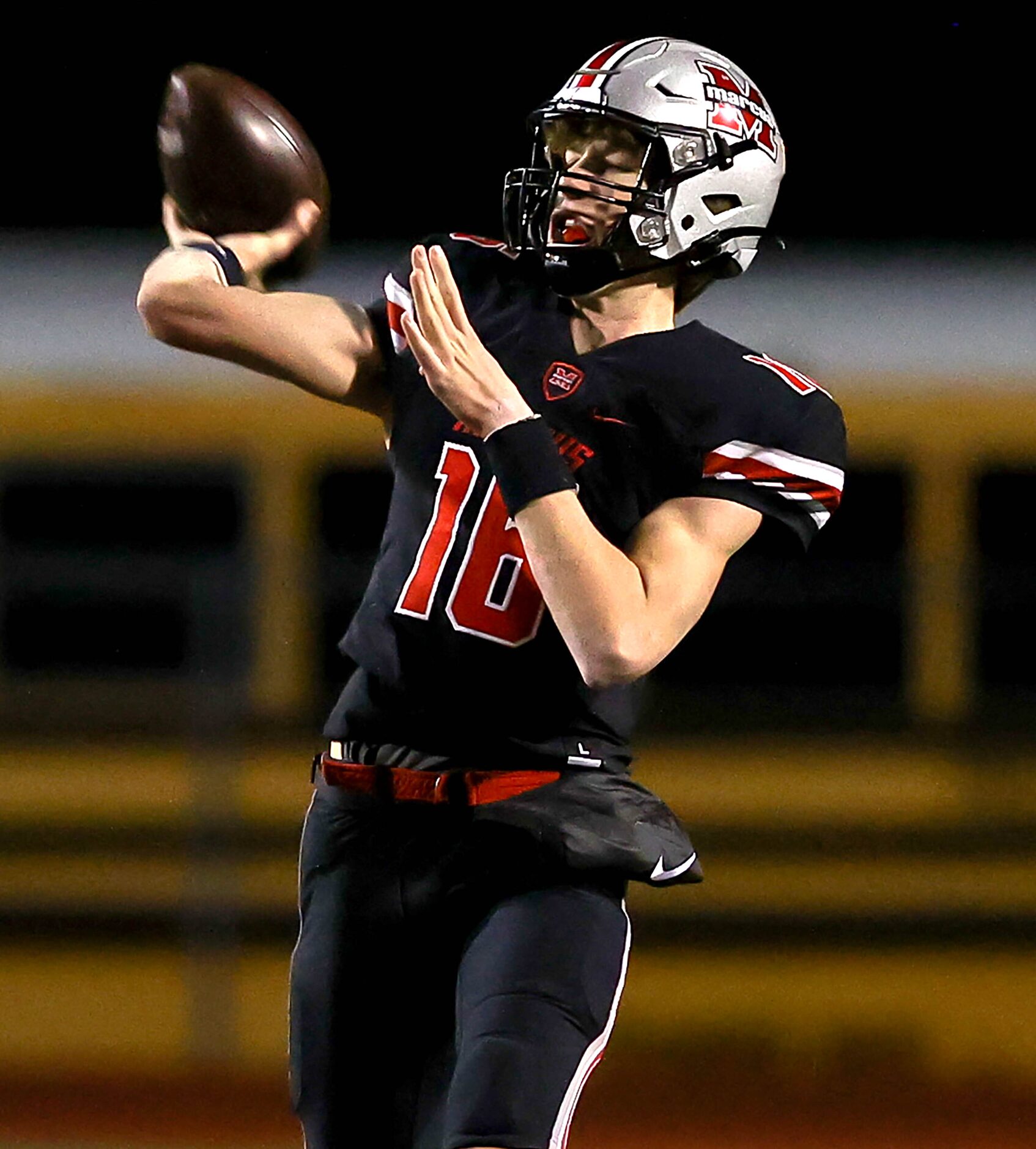 Flower Mound Marcus quarterback Jaxxon Warren looks to make a long pass attempt against...