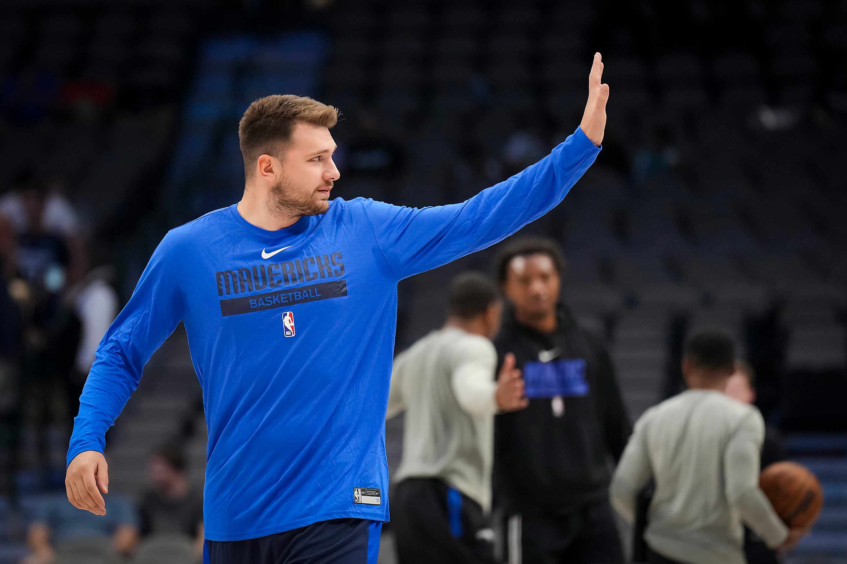 Dallas Mavericks guard Luka Doncic waves to fans as he takes the court to warm up before an...