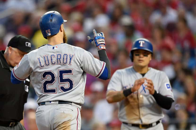 Texas Rangers' Jonathan Lucroy (25) celebrates his two-run home run with Shin-Soo Choo,...