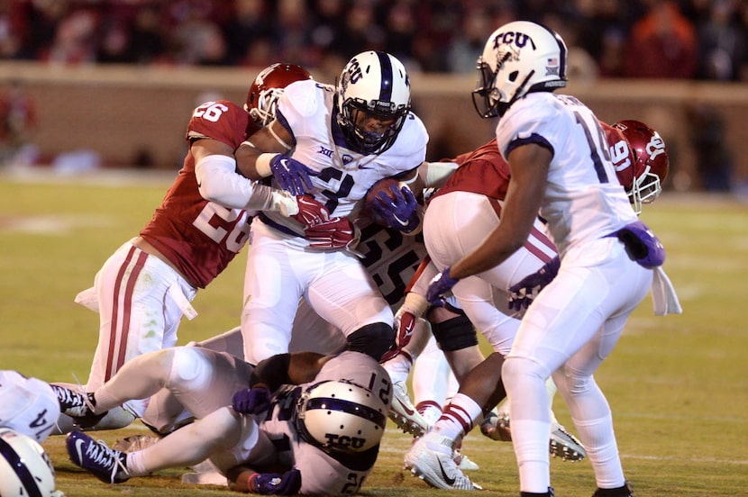 Nov 21, 2015; Norman, OK, USA; TCU Horned Frogs running back Shaun Nixon (3) is tackled by...