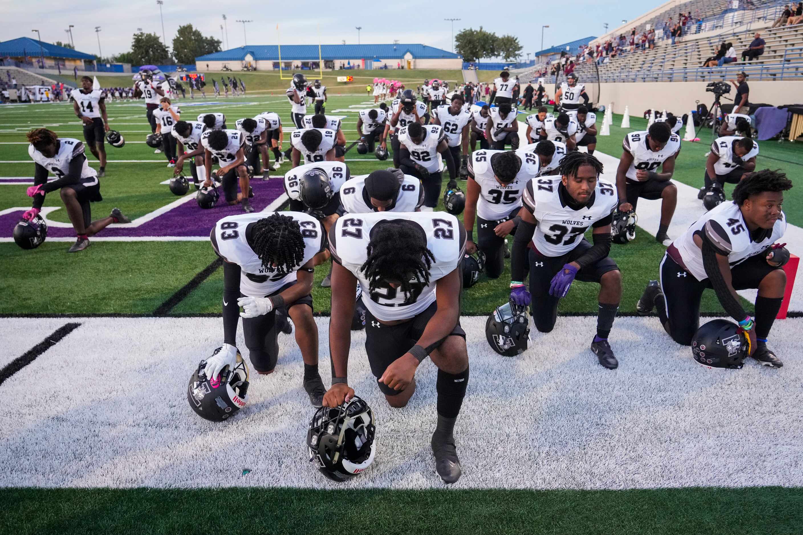 Mansfield Timberview kneel in prayer before facing Waco University in a high school football...