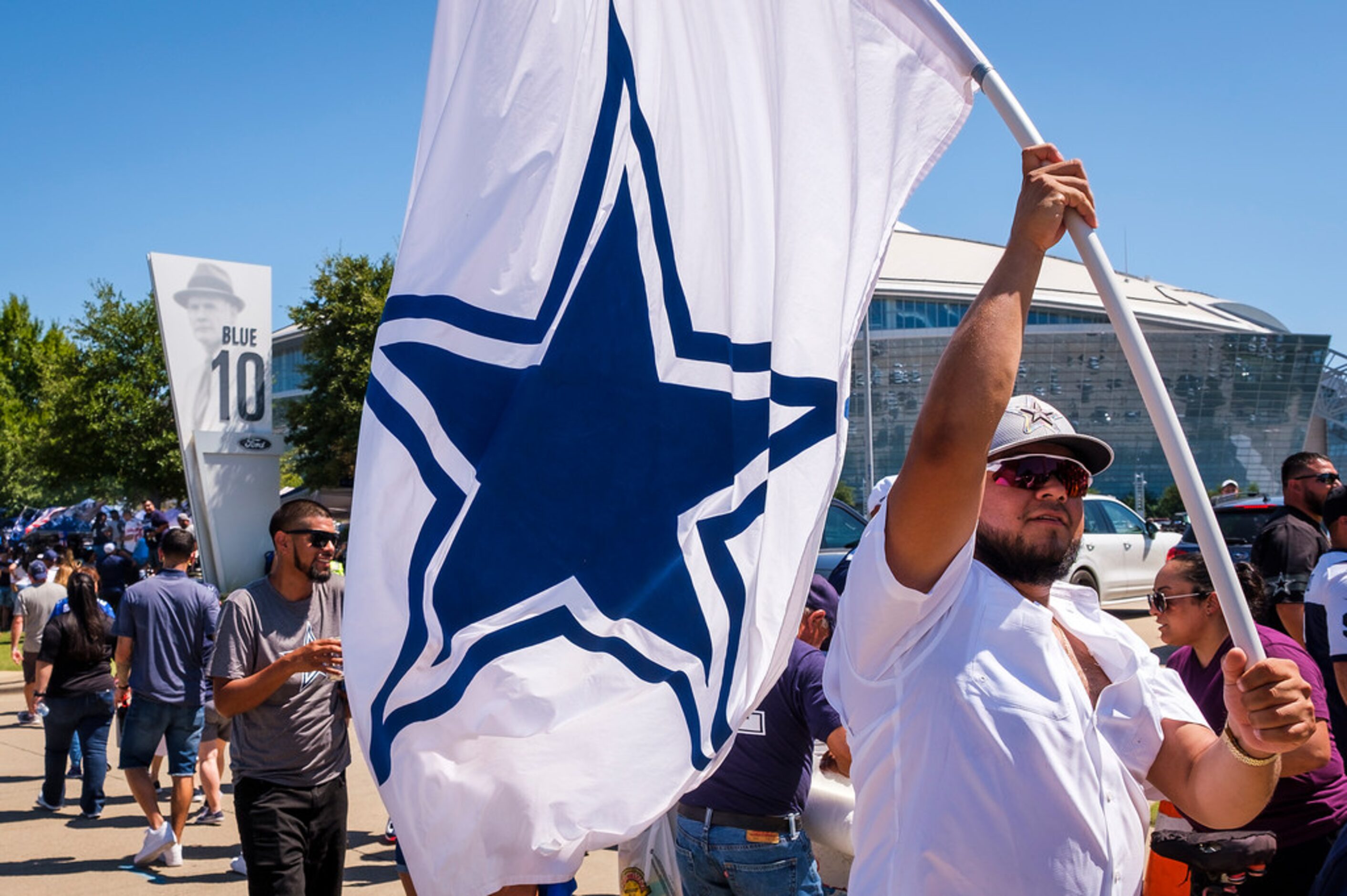 Fans head for the stadium before an NFL football game between the Dallas Cowboys and the New...