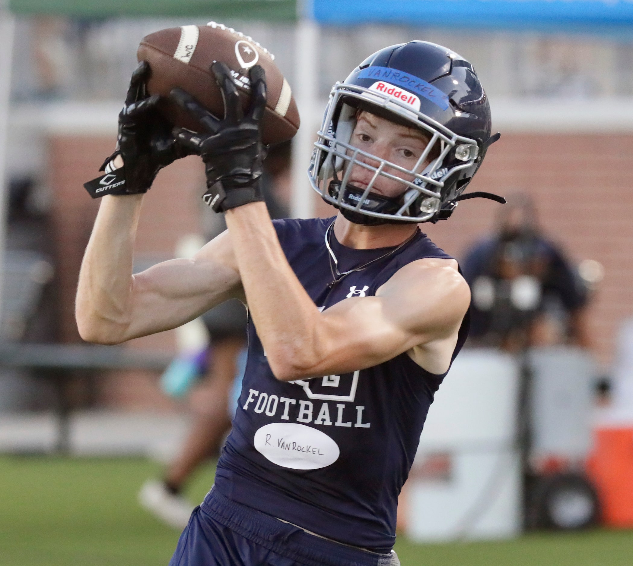 Wide receiver Ryan Van Roekel, 17, makes a catch during a drill as Walnut Grove High School...