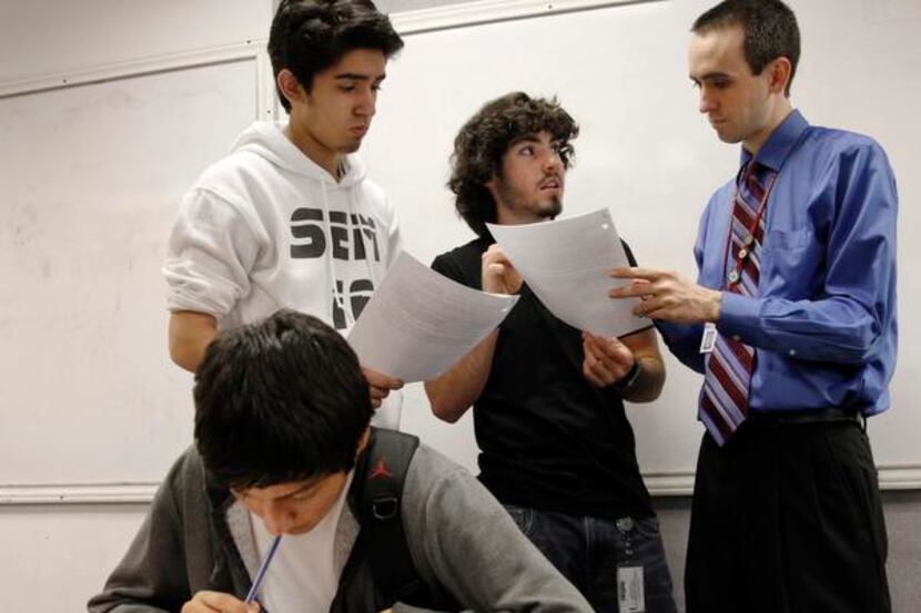 
DISD teacher Josh Newton talks with his AP Calculus AB class, right, helping Shawn Popal,...