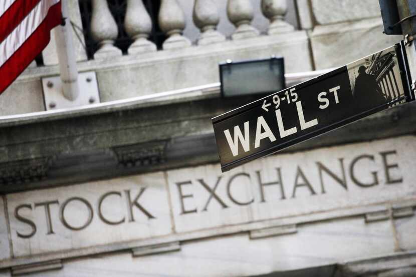 FILE - This July 16, 2013, file photo, shows a Wall Street street sign outside the New York...
