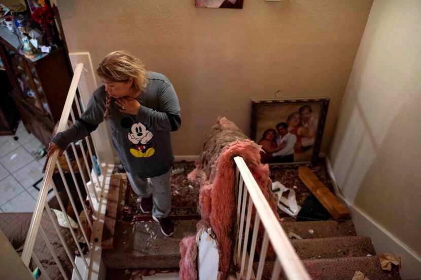 Maria Hernandez looks through her damaged home after an explosion at a northwest Houston...