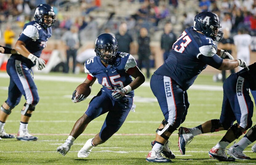 Allen running back Kirby Bennett (45) is the recipient of strong blocking allowing plenty of...