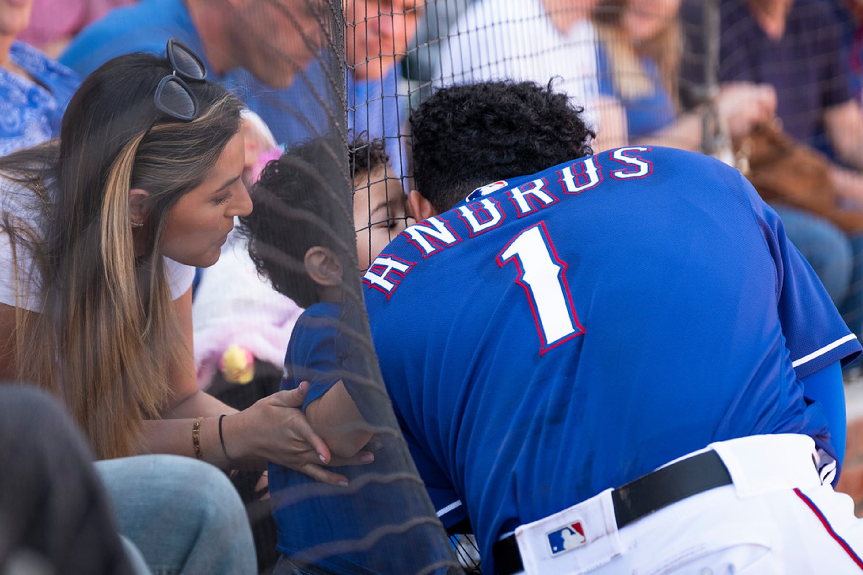 Texas Rangers shortstop Elvis Andrus gets a kiss from his son Elvis as he waits on deck...