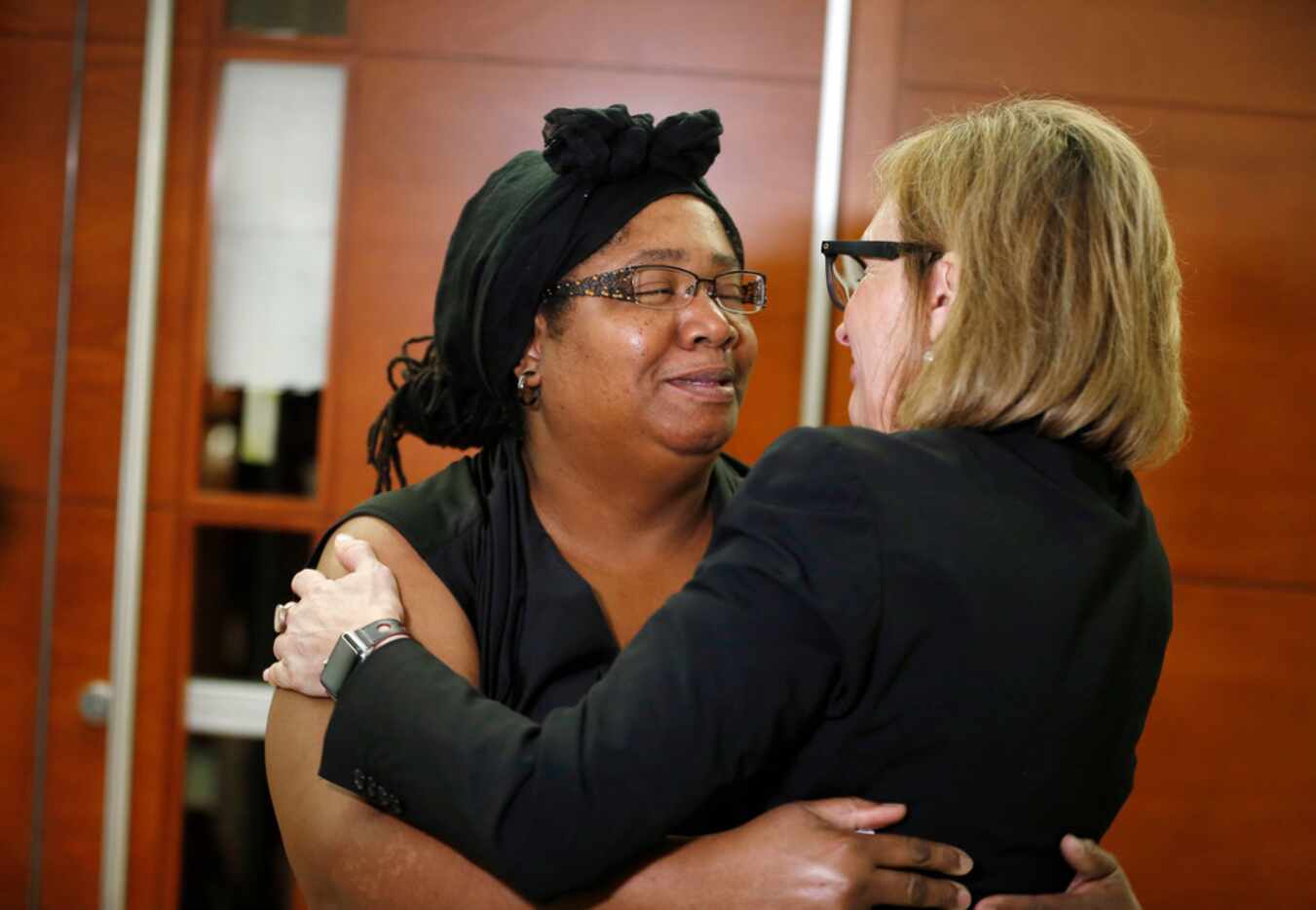 Stacey Jackson (left) hugged her lawyer Charla Aldous after a jury found a Dallas bar...