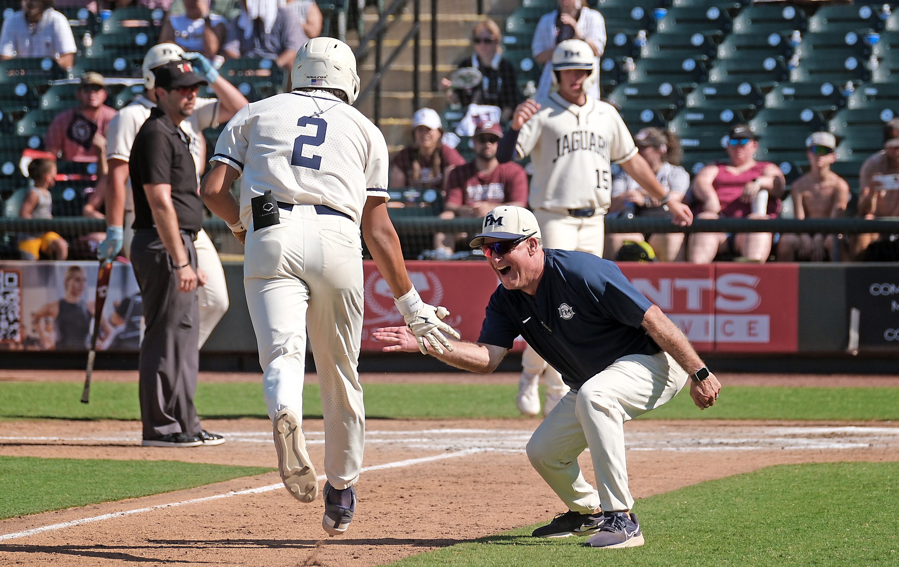 Flower Mound Adrian Rodriguez, (2), celebrates his two-run homer with Flower Mound coach,...