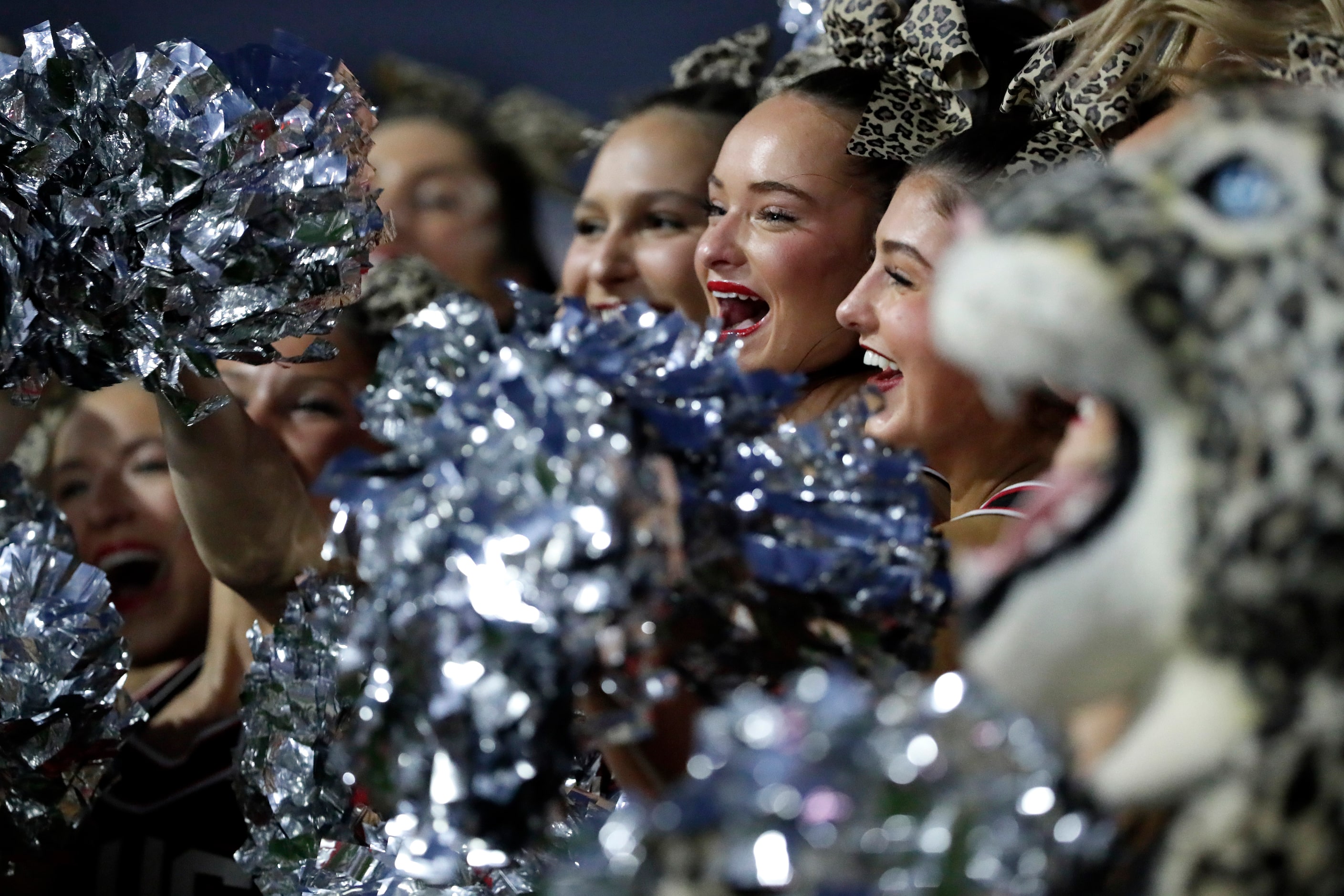 Lovejoy cheerleader Madison Metzger (center), 17, cheers for her team before kickoff as...