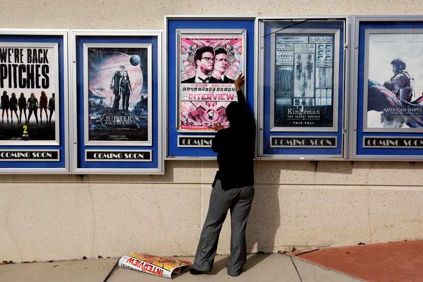 A poster for "The Interview" was taken down by a worker at a Carmike Cinemas movie theater ...