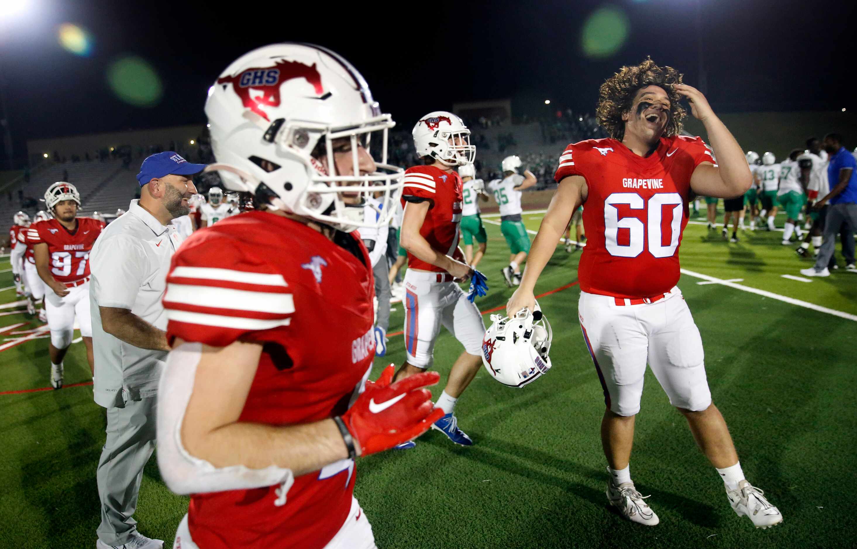 Grapevine defensive lineman Holden Brown (60) and his teammates celebrate their 31-14 win...
