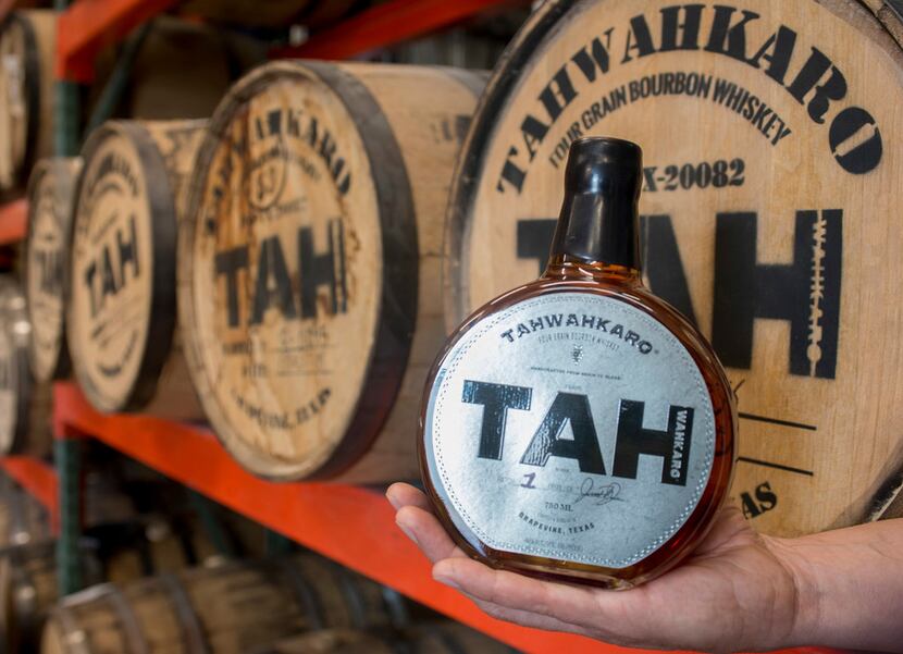 Chris Vivion holds a first-batch bottle of Tahwahkaro four-grain bourbon whiskey at the...