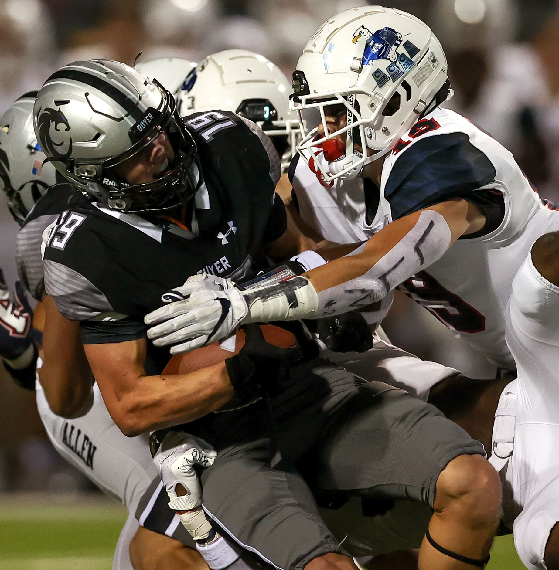 Denton Guyer wide receover Grayson O'Bara (19) is pulled down by Allen linebacker Diego...