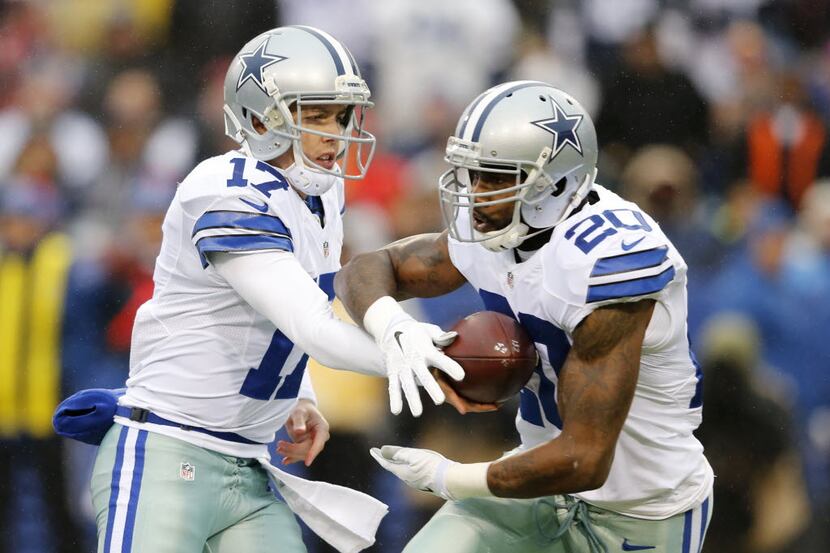 Dallas Cowboys quarterback Kellen Moore (17) hands the ball off to Dallas Cowboys running...
