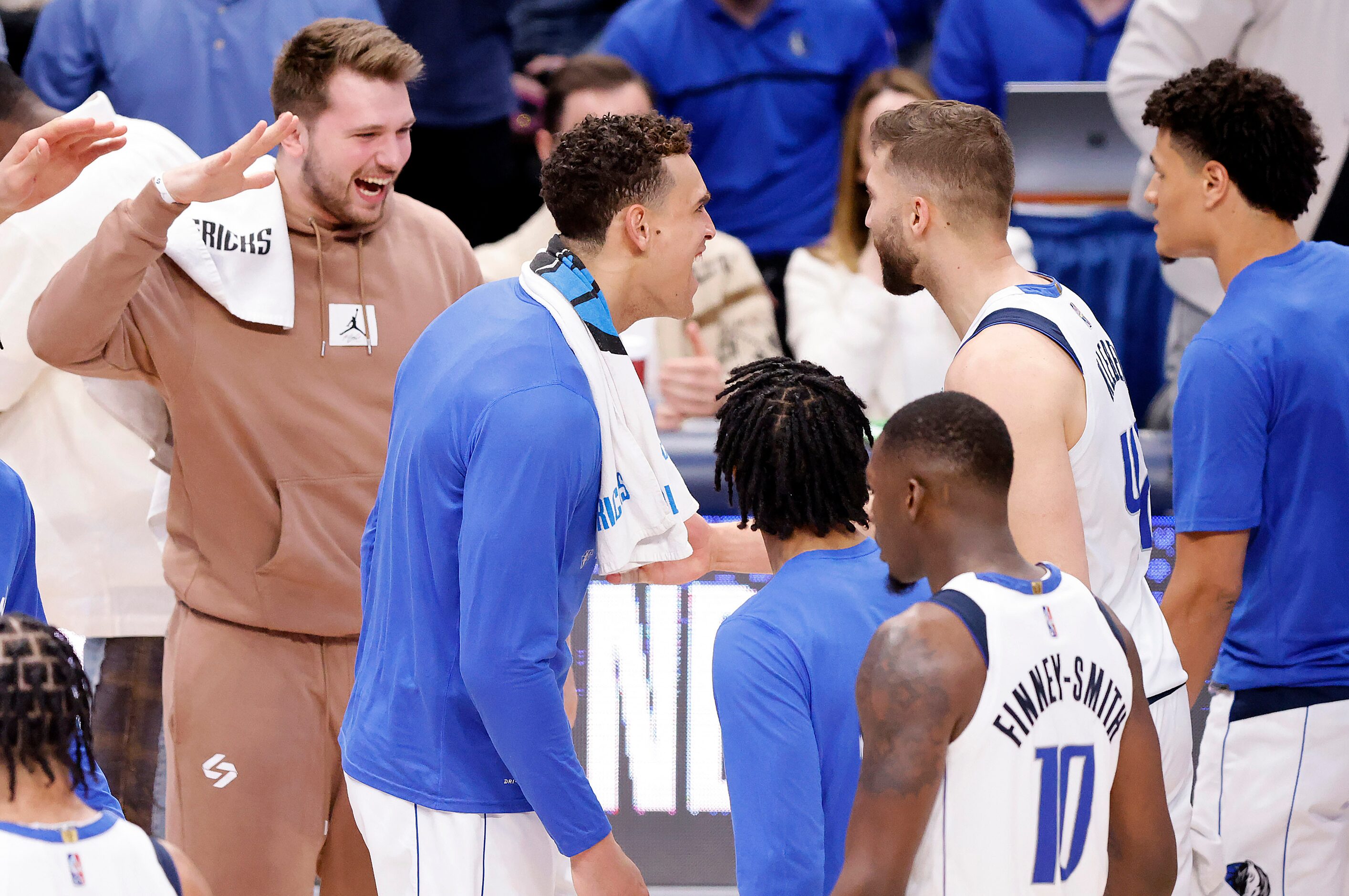 Dallas Mavericks forward Maxi Kleber (42) is congratulated by injured guard Luka Doncic...