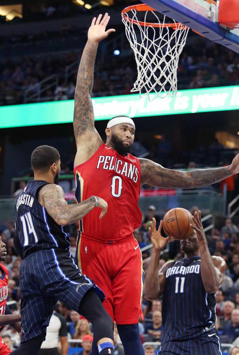 The New Orleans Pelicans' DeMarcus Cousins (0) leaps over the Orlando Magic's D.J. Augustin...