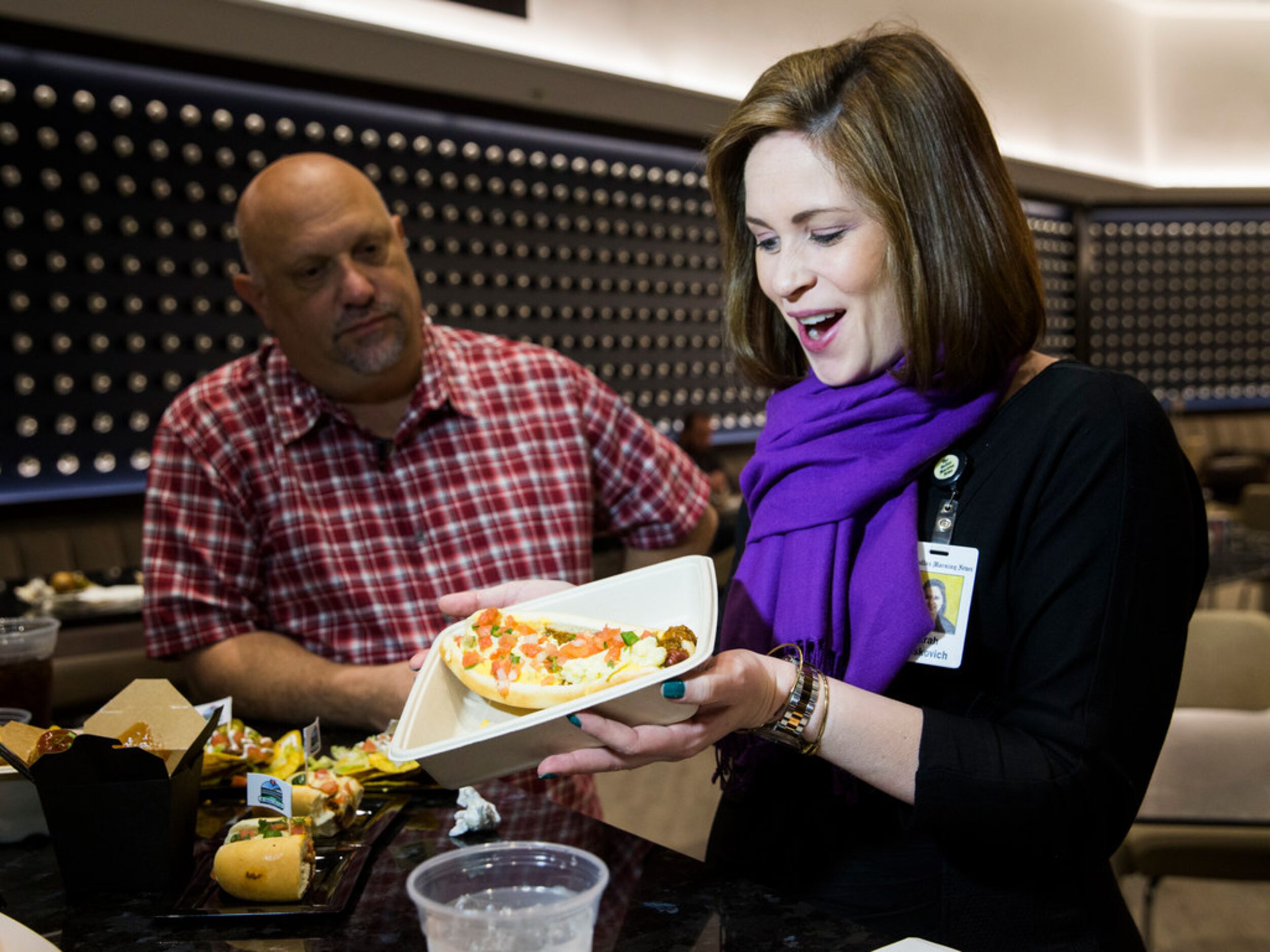 The Dallas Morning News' Evan Grant and Sarah Blaskovich sample new concession stand items...