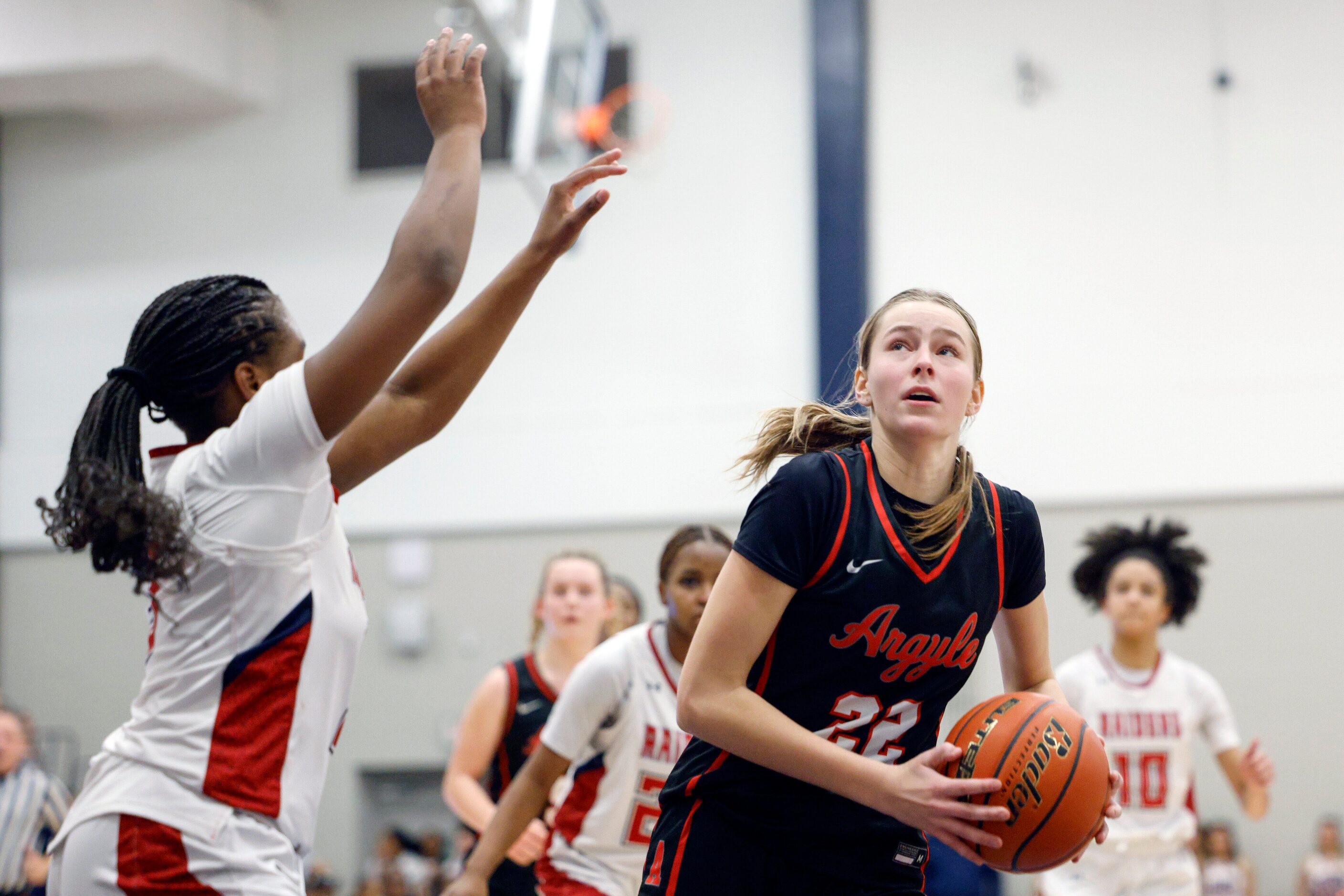 Argyle forward Landry Murphy (22) drives to the basket against Denton Ryan guard Atiya...