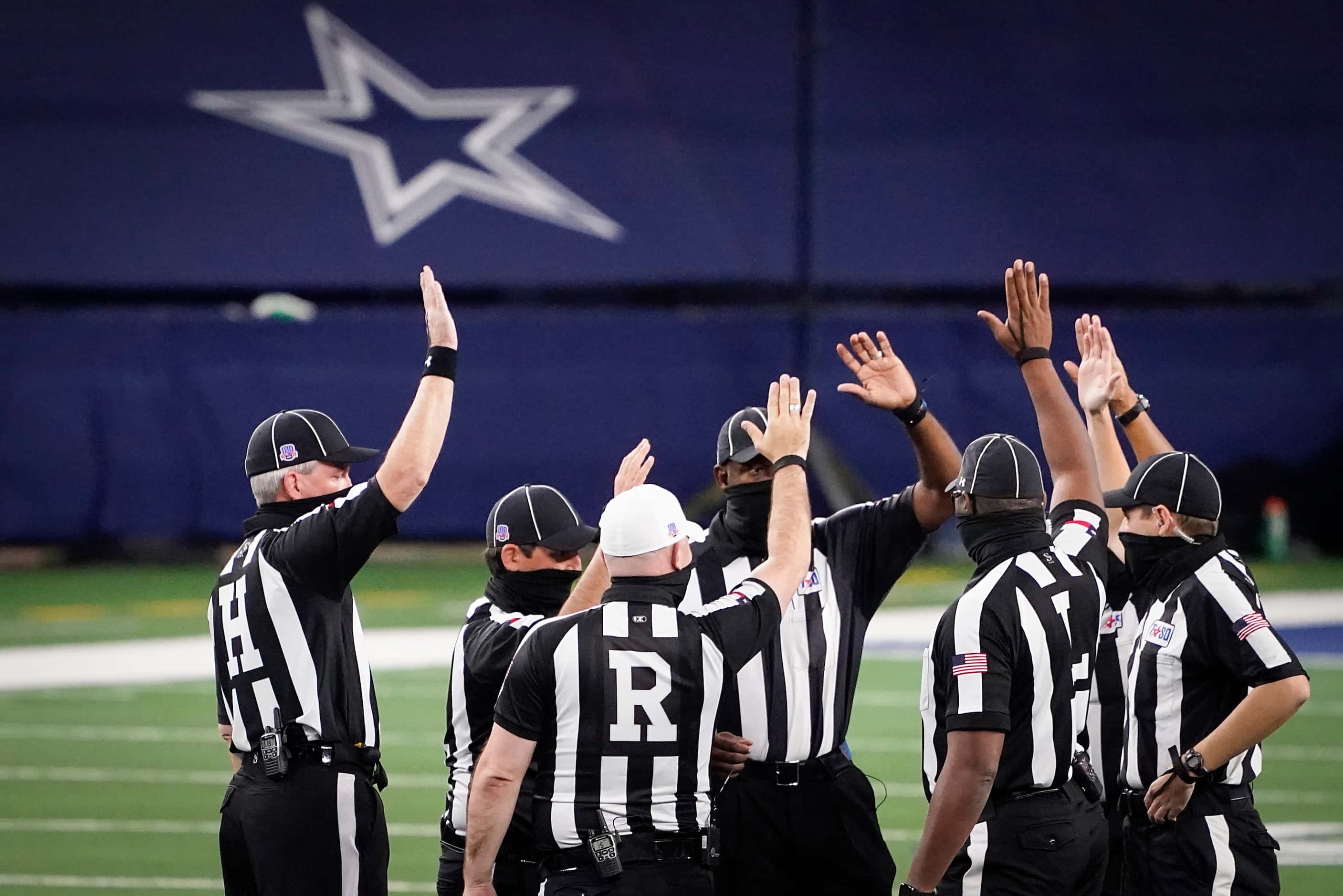 Officials huddle before the Class 5A Division I state football championship game between...