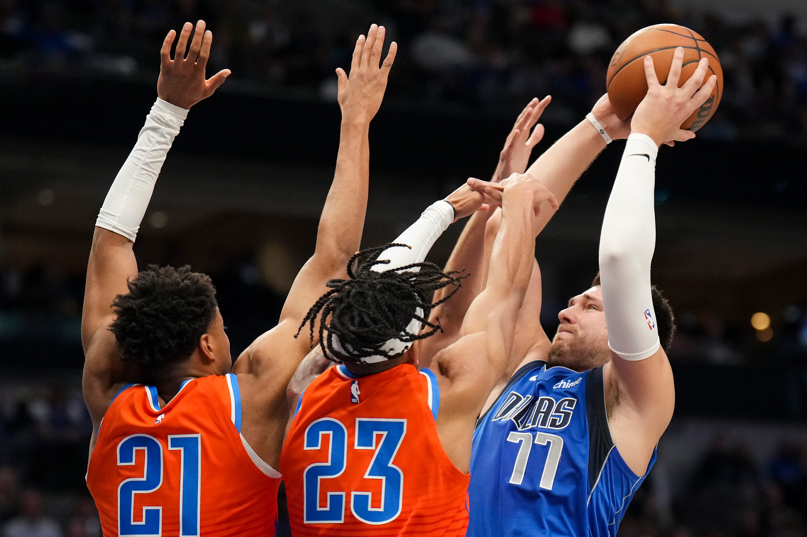 Dallas Mavericks guard Luka Doncic (77) shoots over Oklahoma City Thunder guard Aaron...