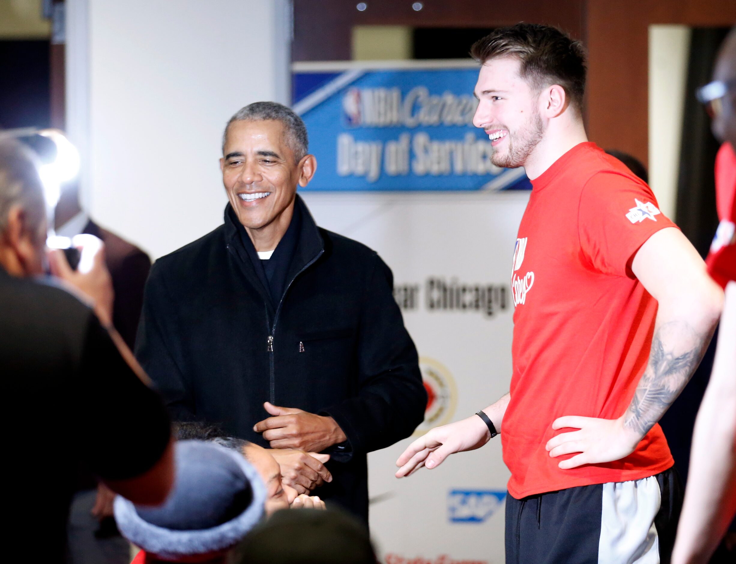 Former President Barack Obama greets Dallas Mavericks forward Luka Doncic (77) during a NBA...