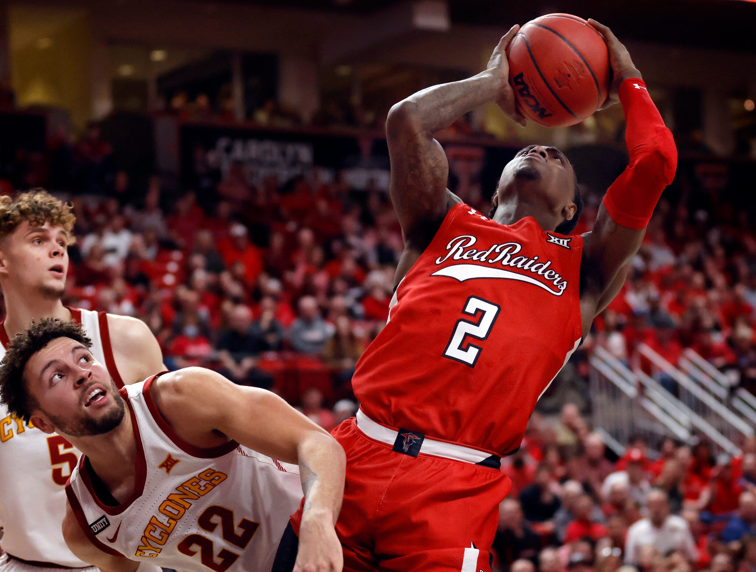 Texas Tech Red Raiders guard Davion Warren (2) puts up an off balance shot against Iowa...