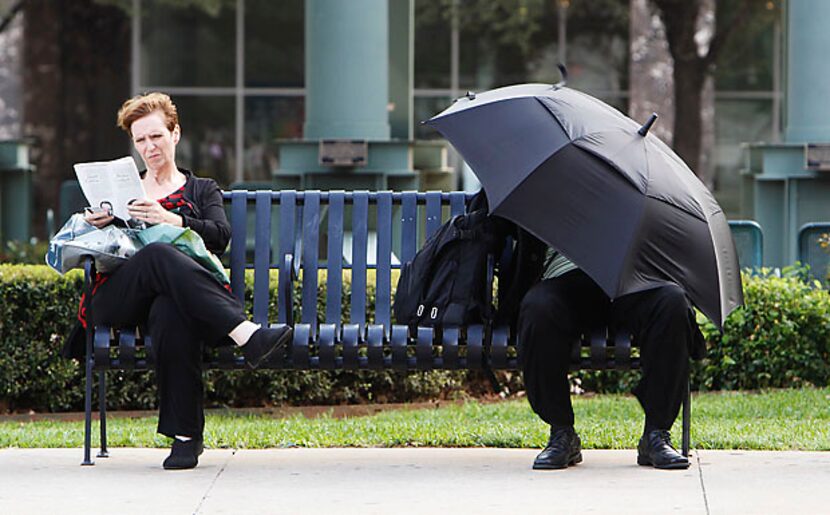 High winds blowing in ahead of approaching storms buffet Lisa Wall (left) and Loyd Collier...