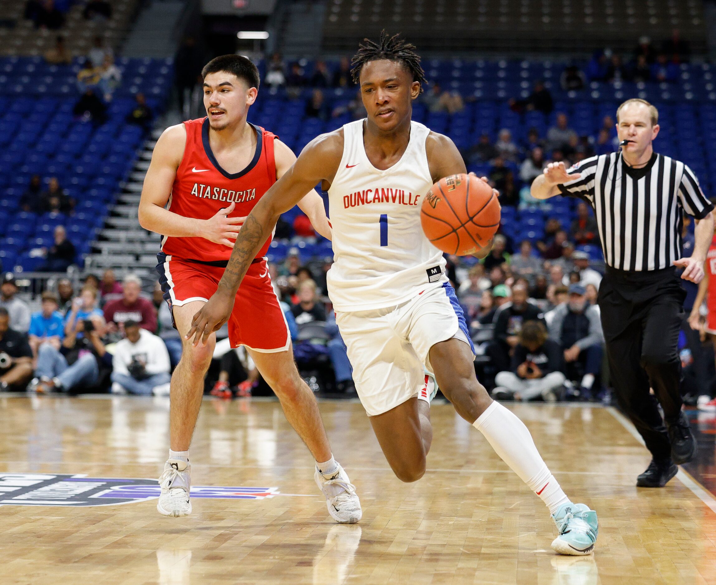 Duncanville forward Ron Holland (1) dribbles down the court ahead of Humble Atascocita guard...