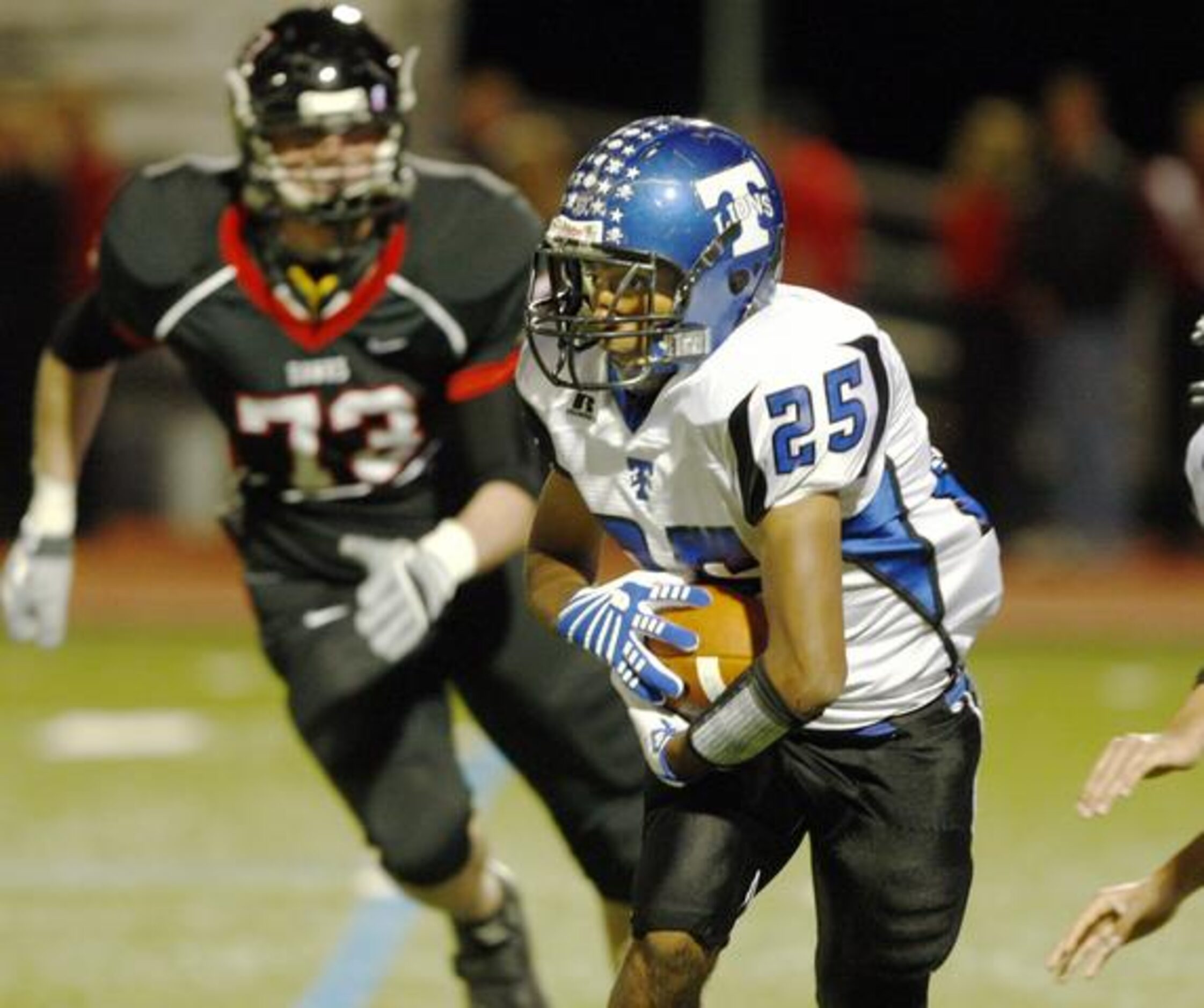 Carrollton R.L. Turner's Anthony Fletes (25) is pursued by Rockwall-Heath's Justin...