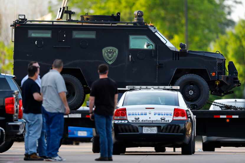 SWAT vehicles are moved into place after an April shooting at a Home Depot in Lake Highlands...
