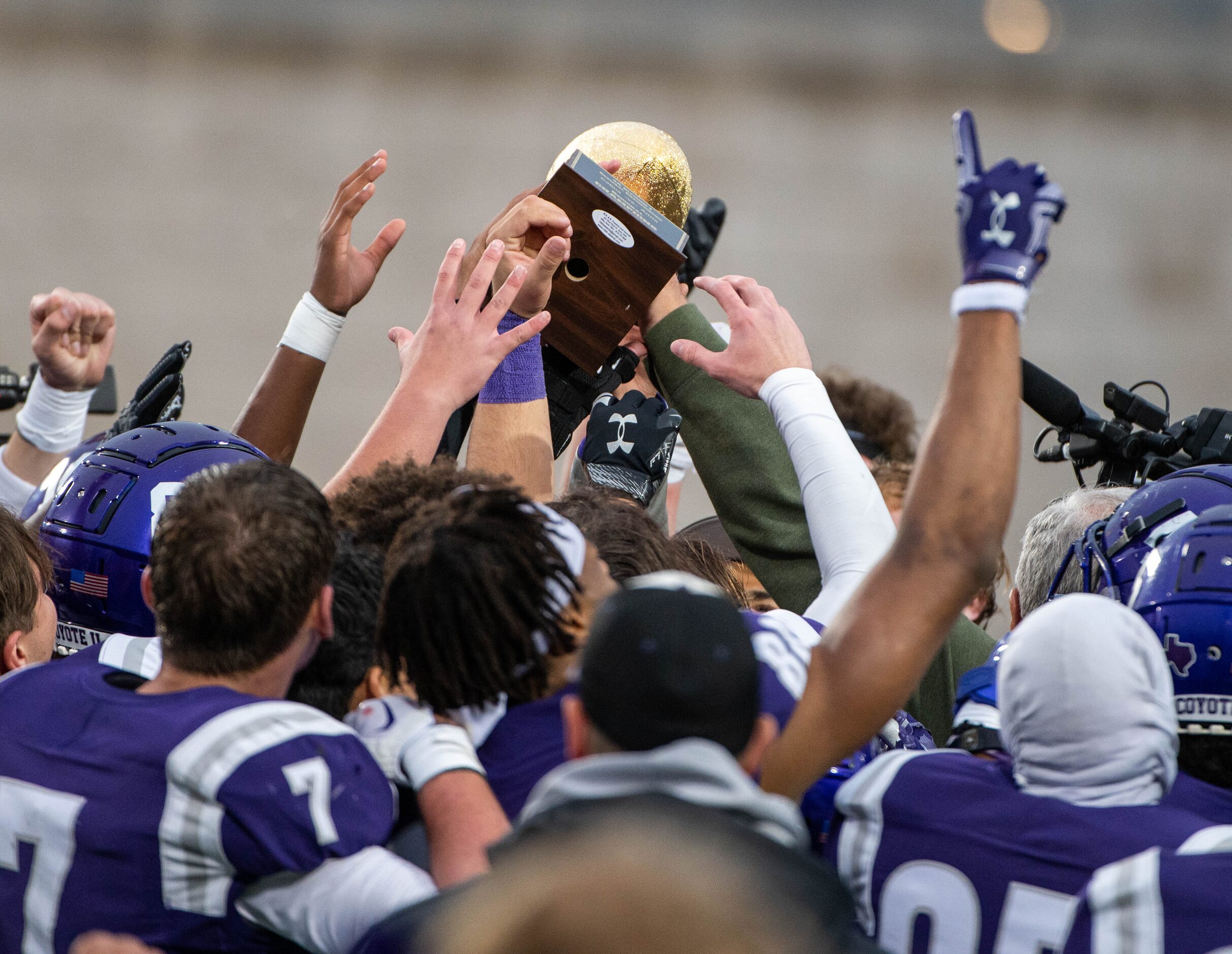 Anna players celebrate with the trophy after their 27-24 win of a Class 4A Division I Region...