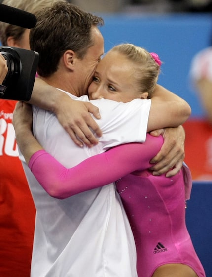 Nastia Liukin gets a hug from her father, Valeri Liukin, after winning gold in   the Women's...