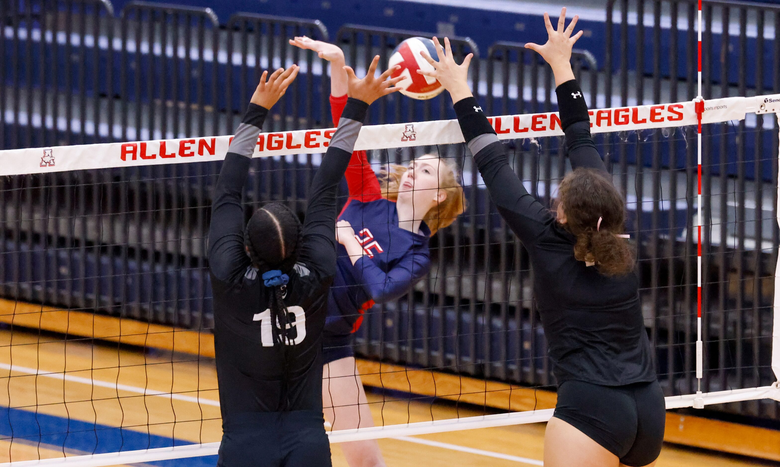 Allen sophomore Katelyn Bowman (25) spikes the ball into Denton Guyer sophomore Sydney...