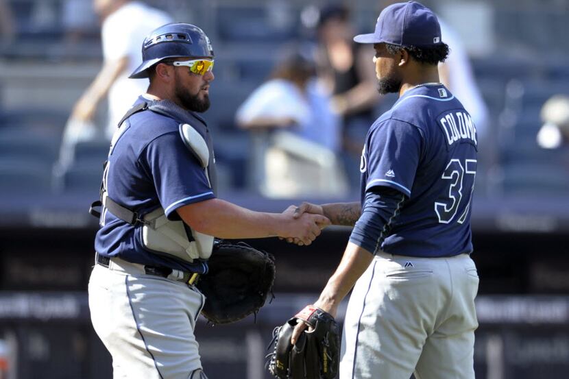 Tampa Bay Rays catcher Bobby Wilson, left, celebrates with pitcher Alex Colome after the...