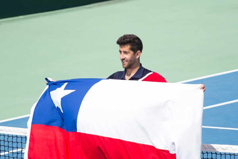 Hans Podlipnik of Chile celebrates with a Chilean national flag during the Davis Cup first...
