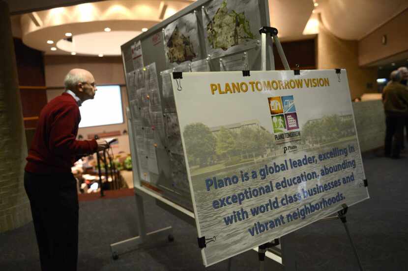  Wayne Moore, a Plano resident, looks at a board detailing the city's new comprehensive plan...