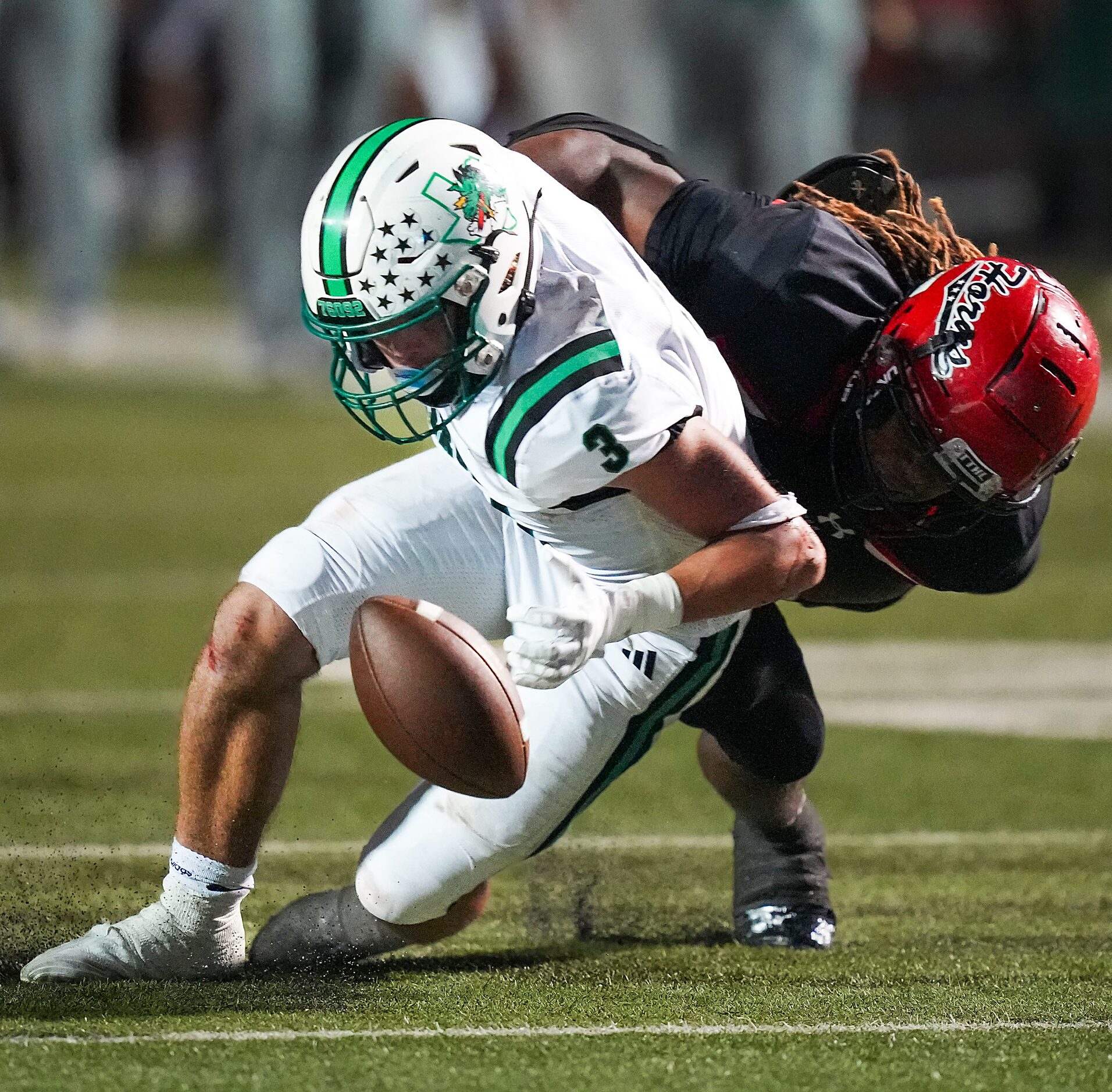 Southlake Carroll running back Davis Penn (3) loses a fumble as he is hit by Cedar Hill...