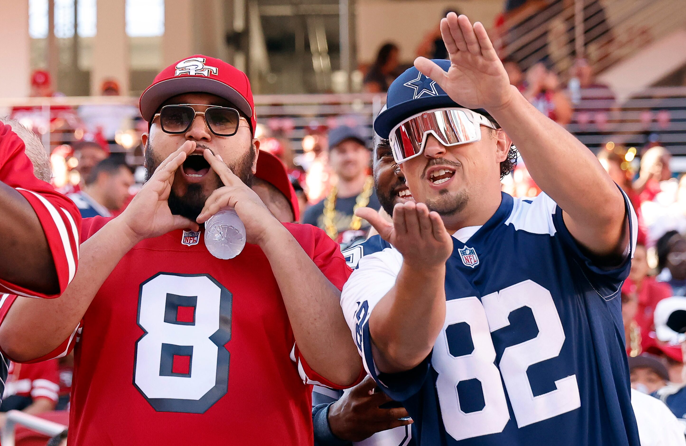 Dallas Cowboys fans cheer and San Francisco 49ers fans boo as the Cowboys finish pregame...