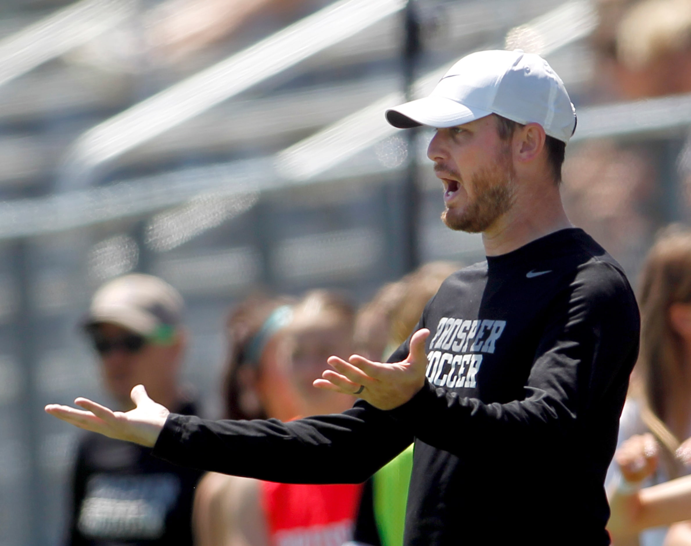  Prosper head coach Matt Dickinson questions a game official after a player was issued a...