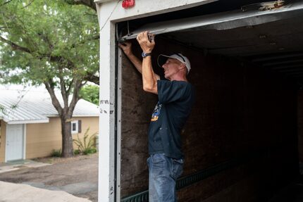 Dwayne Rhodes, 59, fixes a door on a Border Missions truck that brings donated produce from...