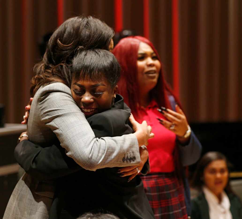 Kaiya McKinney, 17, of Young Women's Leadership Academy in Grand Prairie, gets a hug from...