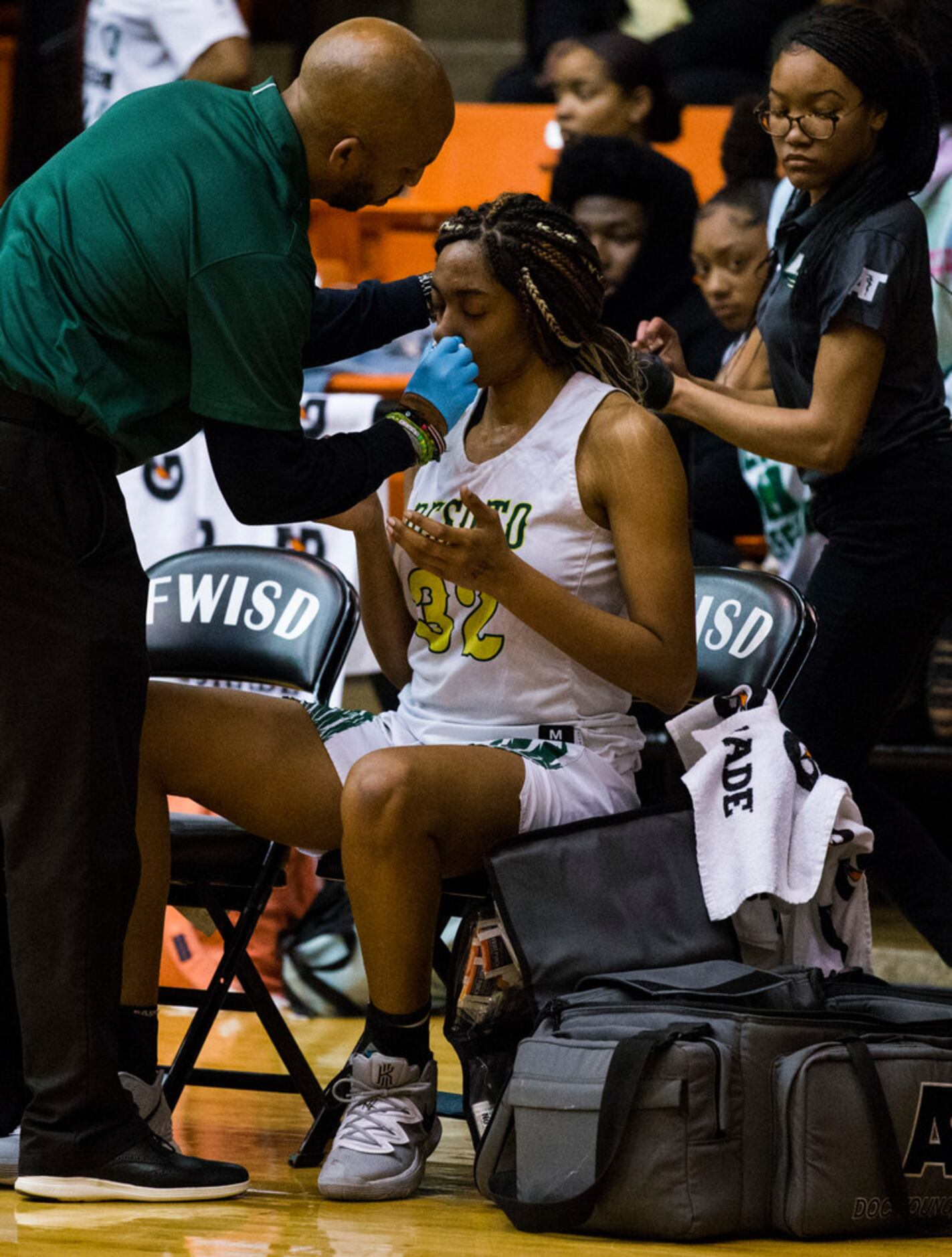 DeSoto's Tina Herron (32) is treated after an injury during the third quarter of a Class 6A...